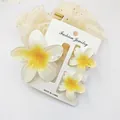 Detailed view of sweet plumeria flower hair clip set on a white display card for summer - 3-Piece Set (1 Large 2 Small) / White and Yellow