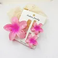 Close-up of three pink plumeria flower hair claw clips in a summer resort jewelry set - 3-Piece Set (1 Large 2 Small) / Pink + Pink