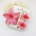 Close-up view of pink gradient frangipani hair clip 3-piece set on display card - 3-Piece Set (1 Large 2 Small) / Pink and Red