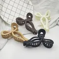 Macro detail view of four matte bow-shaped hair claw clips on white textured fabric - 13CM Large Bowknot (4-Piece Set) / 4 Pieces/Pack