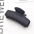 Close-up of black matte rectangular hair claw clip for elegant hairstyling - Matte Black