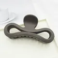 Close-up of a large matte dark brown hair claw clip with a figure-eight hollow design. - Dark Coffee
