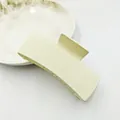 Detailed shot of a matte creamy yellow rectangular hair claw clip for stylish hair styling - Ivory