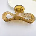 Detail view of translucent amber jelly hair claw clip with sleek minimalist design - Jelly Coffee