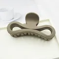 Minimalist large matte brown hair claw clip with elegant bow design on a clean white tray - Light Coffee