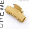 Close-up of a matte yellow rectangular hair claw clip with a sleek minimalist French design - Matte Khaki