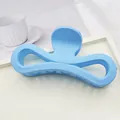 Detailed view of a large matte blue bow-shaped hair claw clip on a clean white tray - Sky Blue