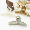 Detailed view of large jelly-textured hair claws in multiple soft summer colors - White + Grey + Coffee