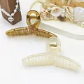 Macro view of translucent jelly texture large hair claw clips in amber and cream white - Pack of 2 / White and Brown
