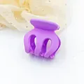 Detailed macro view of a small purple matte hair claw clip for securing high ponytails. - Purple