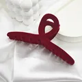 Close-up detail of a large red velvet hair claw clip with an elegant twisted design - 13 Streamer Style / Burgundy