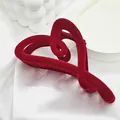 Detailed macro view of a large red velvet heart-shaped hair claw clip on white fabric. - 12 Heart Style / Burgundy