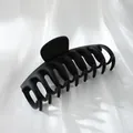 Macro view of a professional large matte black hair claw clip on white silk background - 11cm Dragon Bone Style / Matte Black
