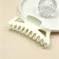 Close-up detail view of a large minimalist matte cream hair claw clip for thick hair styling - Off White