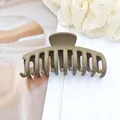 Close-up of matte olive green dragon bone hair claw clip for thick hair. - Light Coffee