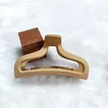Detail view of a matte beige hair claw clip with elegant ingot shape on white fur - Yuanbao Style (14) / 9.5cm Size / Khaki