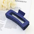 Detailed view of a navy blue matte square hair claw clip on printed background - Navy Blue