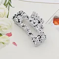 Detail view of a square hair claw clip featuring a black ink splatter pattern on white - Cube Style / 8.5cm Size / Speckled White