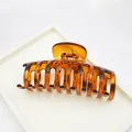 Detailed view showing the glossy texture and metal spring of a leopard print hair claw clip - Backbone Style / 9cm / Red Leopard