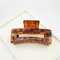 Detail showing the glossy texture of a large leopard print hair claw clip accessory. - Hollow Square Style / 8.5cm / Red Leopard