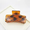 Close-up view of a large leopard print hair claw clip made of durable amber plastic - Solid Square Style / 8.5cm / Red Leopard