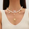 Detailed view of layered gold necklace with faux pearls, seashells, and starfish charms - Three-Layer Layered Ocean Style Necklace / Gold