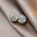 Macro view of silver-toned magnetic sphere earrings encrusted with clear rhinestones - 1 Pair / Silver White Stone