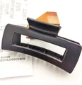 Close-up of a matte black square hair claw clip with a hollow rectangular design. - Square Style (12*) / 10.5cm / Matte Black