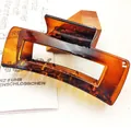 Detailed macro shot of a high-quality amber PC material large square hair claw clip - Square Style (12*) / 10.5cm / Glossy Brown Tortoise Shell