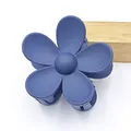 Close-up of a matte navy blue five-petal flower hair claw clip with a shark clip design. - Navy Blue
