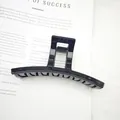 Close-up detail of a large glossy black hair claw clip for elegant bun hairstyles - Glossy Black
