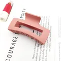 Close-up detail of a matte pink square hair claw clip with nonslip design on white paper - Deep Pink / 8.5cm