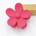 Macro view of hot pink matte five-petal flower hair claw clip for elegant hair styling - Rose Red