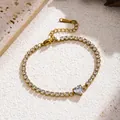 Detailed view of gold tennis bracelet featuring sparkling heart-shaped zircon stone. - White Heart Style