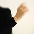 Minimalist 18K gold-plated titanium steel snake chain bracelet shown on a model's wrist - Bracelet (5425) / Gold