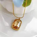 Detailed macro view of champagne square gemstone pendant on gold stainless steel chain - Champagne Necklace (86617) / Champagne