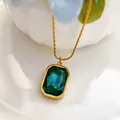 Close-up of elegant rectangular emerald green gemstone pendant with gold chain necklace - Green Necklace (86346) / Green