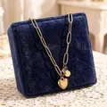 Detailed view of gold stainless steel heart pendant necklace on blue velvet jewelry box - Necklace (86604)