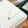 Elegant light blue heart-shaped birthstone pendant necklace with a delicate gold chain - March Sky Blue