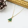 Macro detail of a delicate gold-plated Christmas tree pendant necklace with green enamel - Christmas Tree Style B (7)