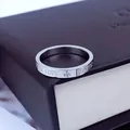 Close-up of silver titanium steel ring with Forever Love engraving on premium gift box. - Size 5 / Silver
