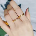 Close-up of minimalist gold textured titanium steel rings worn on index and middle fingers - Size 5 / Square Style (388) / Gold