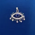 Detailed evil eye pendant charm with blue stones on a blue textured background - Silver Evil Eye Style (733) / Pendant Only (Without Chain)