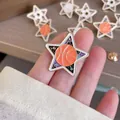 Close-up detail of a star-shaped basketball enamel pin with vibrant orange finish - Pentagram Basketball Style (XZ566215) / Basketball