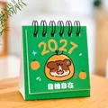 2027 green mini desk calendar featuring a cute cartoon dog and pomelo design for office decor - Carefree Life / 6.5x3.8x7.5cm
