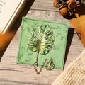 Creative gold-plated metal Monstera leaf bookmark featuring a green enamel finish and charm - Monstera (W883) / 1 Piece