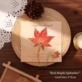 Red maple leaf metal bookmark with gold chain and matching leaf charm on backing card - Gradient Maple Leaf