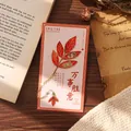 Exquisite gilded red leaf metal bookmark with gold accents on decorative gift card - Red Character Leaf