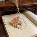 Close-up detail of an exquisite metal bookmark featuring a cat and roses with tassel - Style C (Curled Cat with Roses) / Gold/White