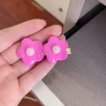 Close-up of cute bright pink flower hair clips held in hand showing resin material details - Flower / Rose Red